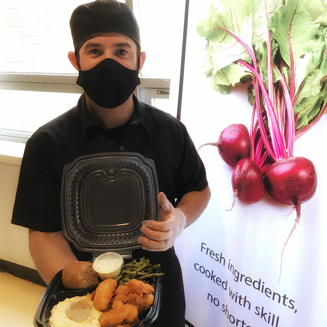 Chef holding Sam's chicken dish