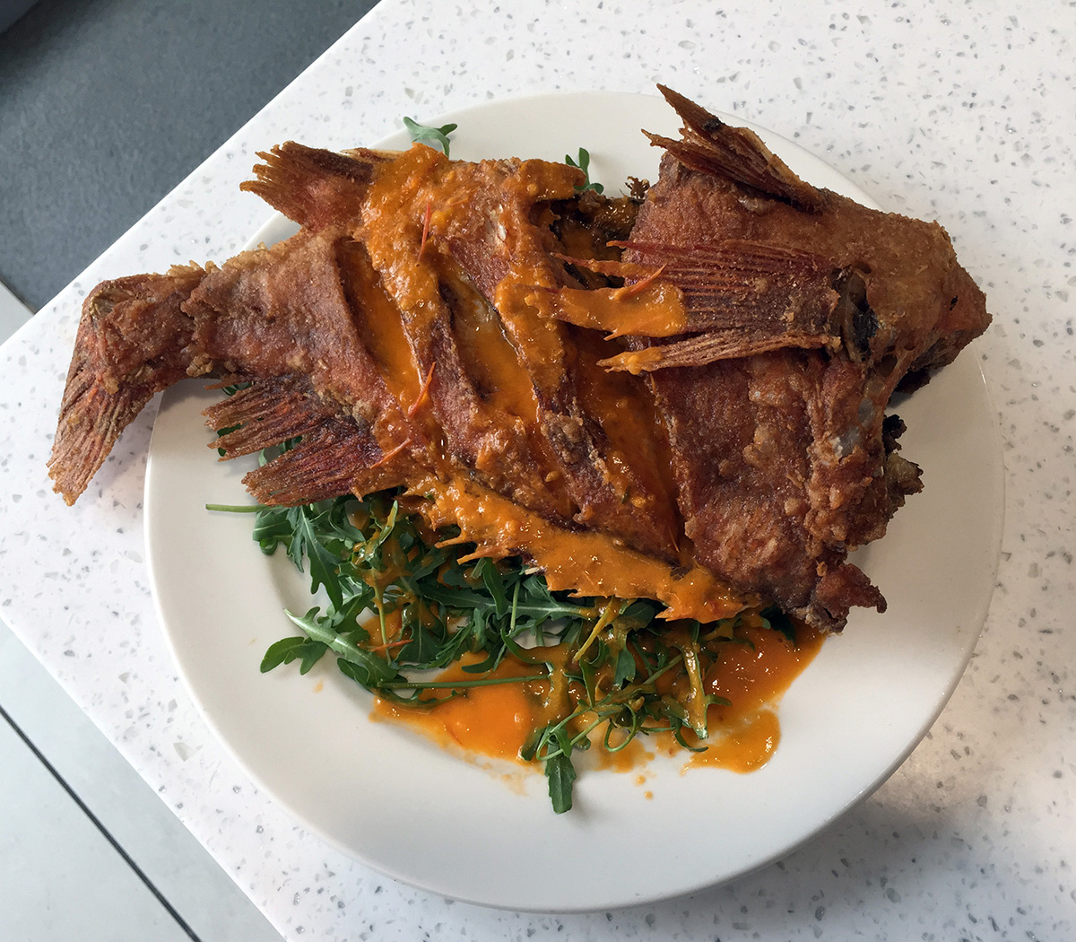 A whole fried fish served at Samsung by our Executive Chef Nicolai Tuban
